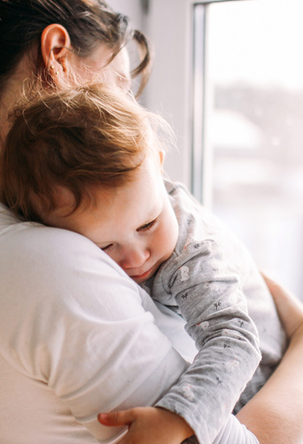 baby sleeping on mothers shoulder