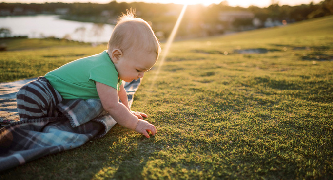cute baby playing in the grass