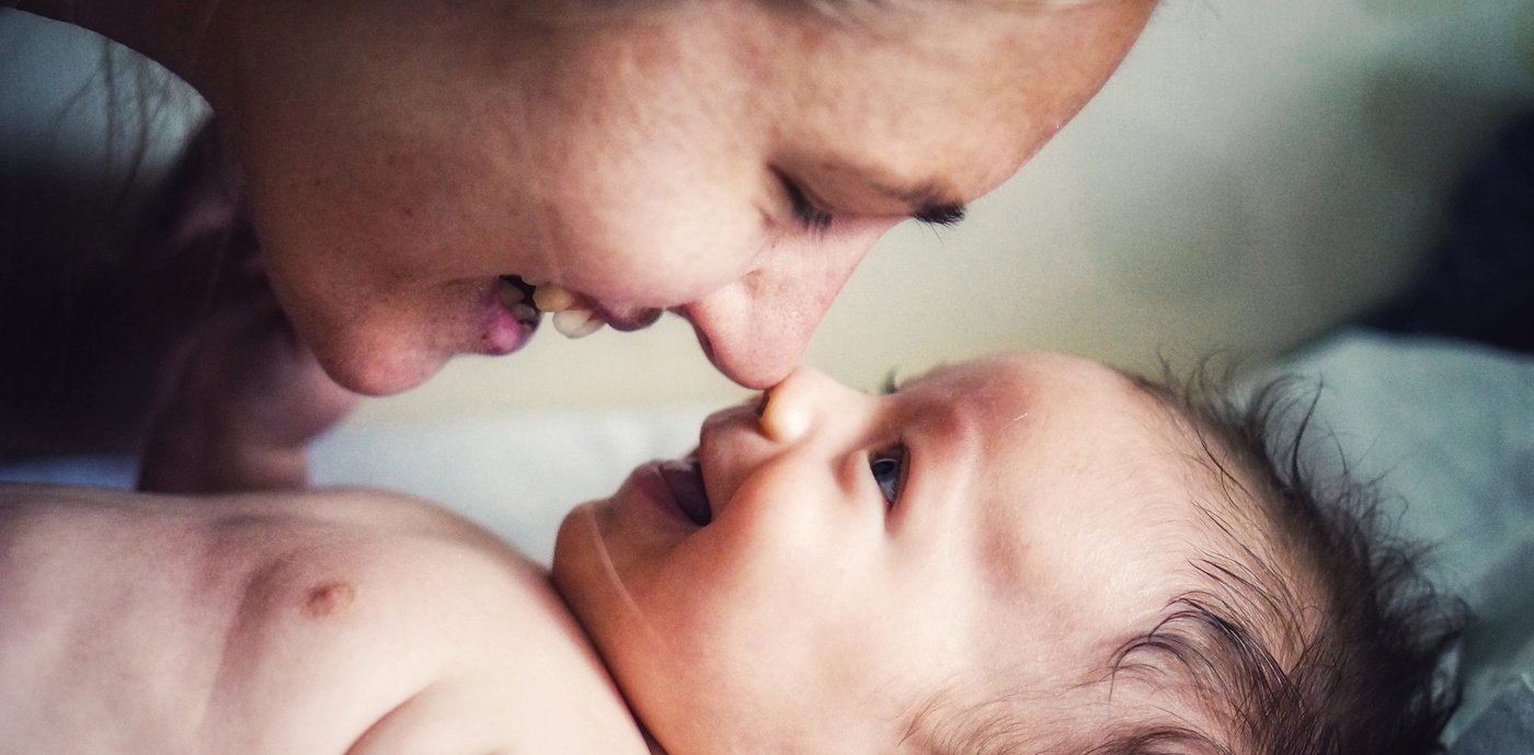baby smiling at mom