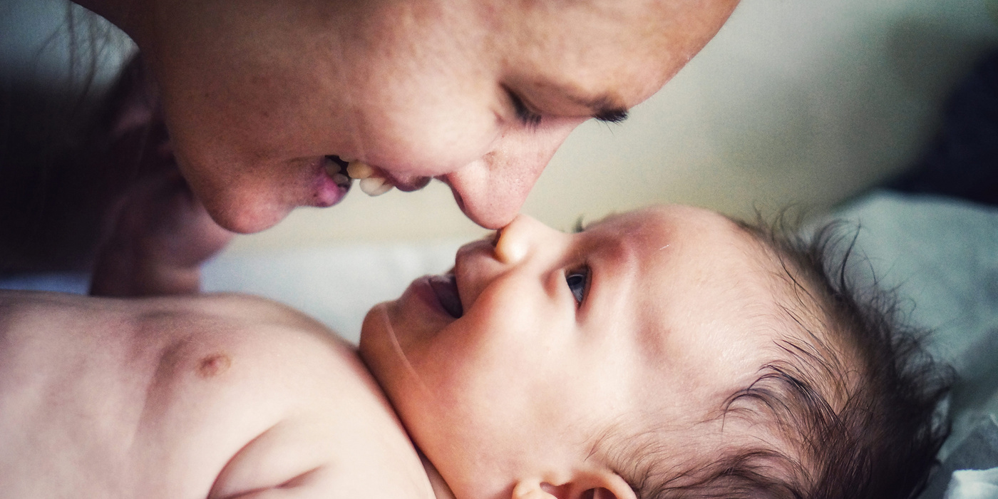 baby smiling at mom
