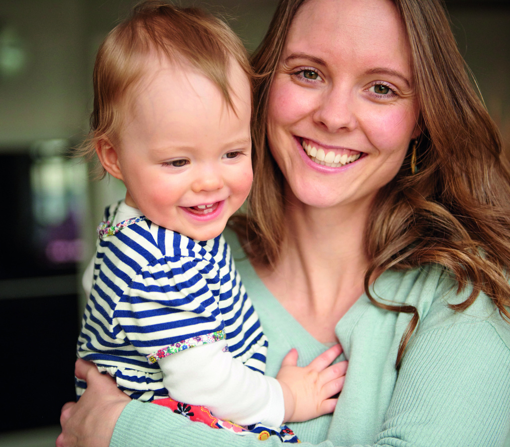Happy mother carrying happy baby 