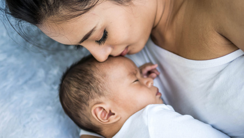 baby sleeping calmly beside mommy 