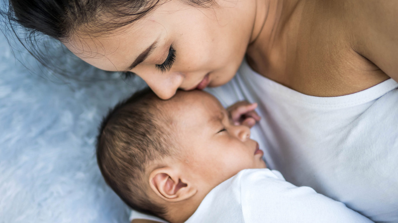 baby sleeping calmly beside mommy 