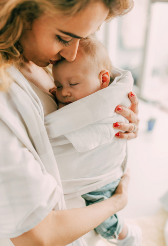 mom holding her baby close 