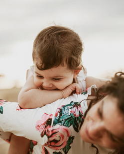 happy baby riding on mom's back